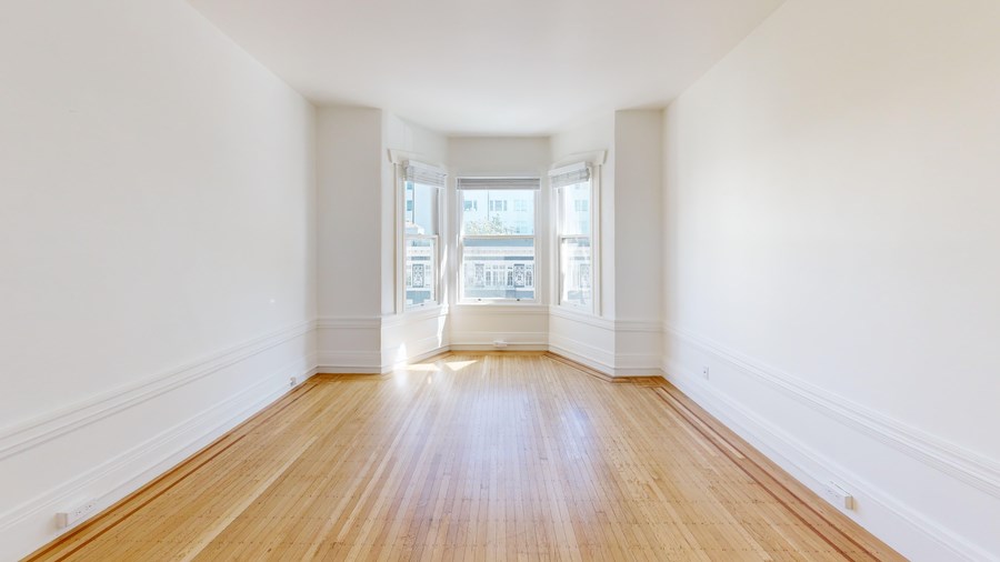 A room with wooden floors and white walls.